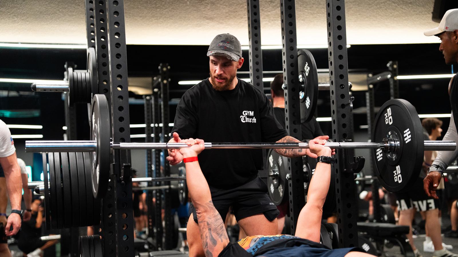Men spotting each other on the bench press at a Gym Church session