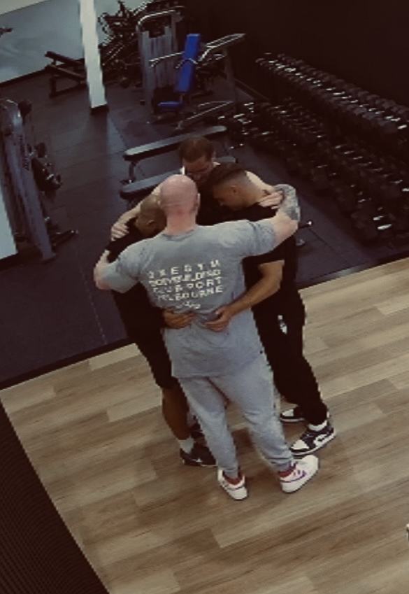 Security camera footage of the first four Gym Church men praying together in a gym