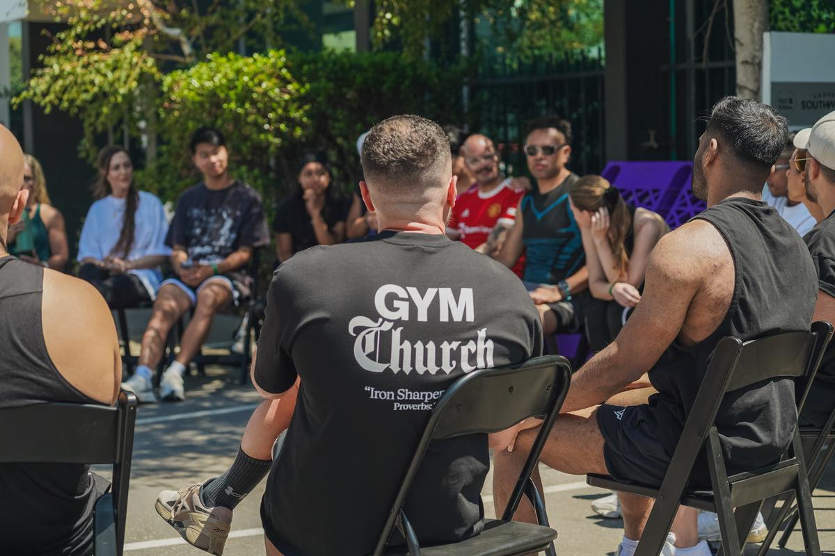 Men and women circled up outdoors at the Gym Church Gold Coast event